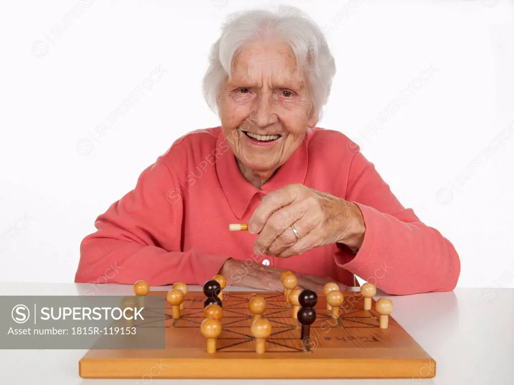 Portrait of senior woman playing Fox And Hen Game, smiling