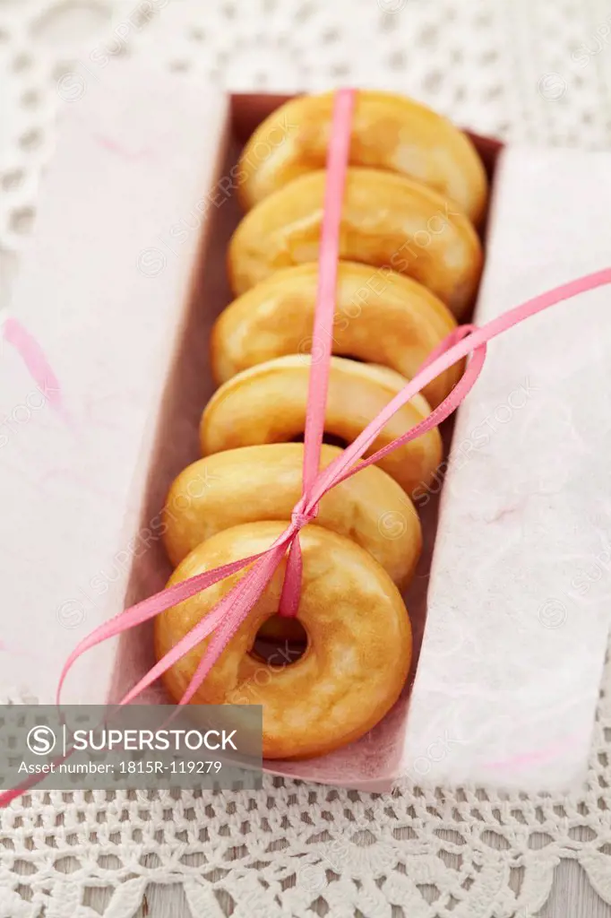 Baked doughnuts in box on table