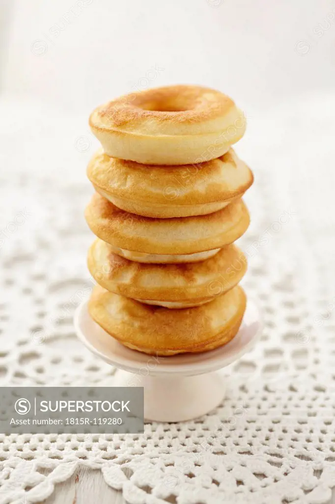 Stack of baked doughnuts on doily