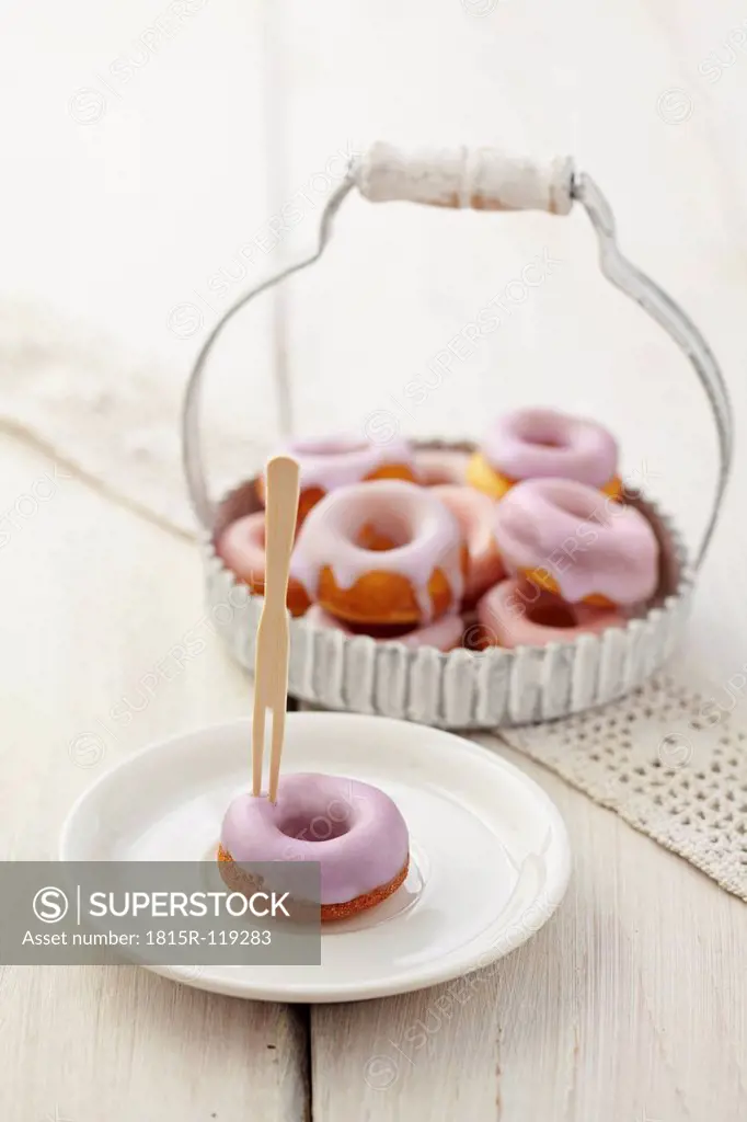 Glazed baked doughnuts on tray and plate
