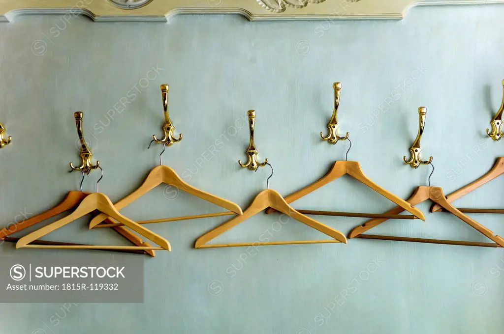 Wood coathangers in wardrobe, close up