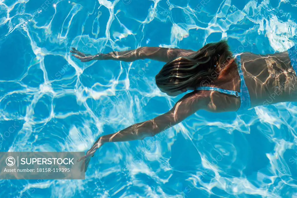 Italy, Mature woman diving in swimming pool