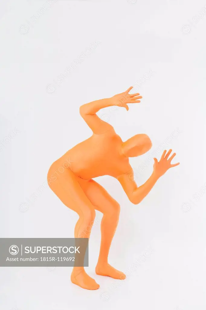 Mature man gesturing in orange zentai on white background