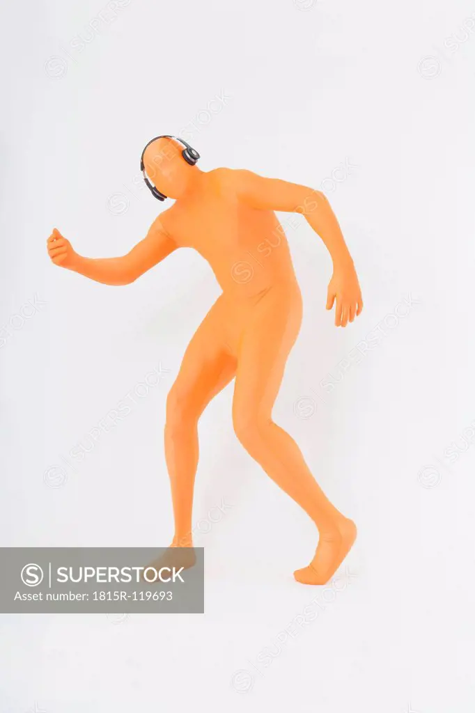 Mature man in orange zentai listening music