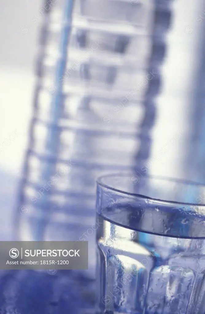 Glass of water and plastic bottle