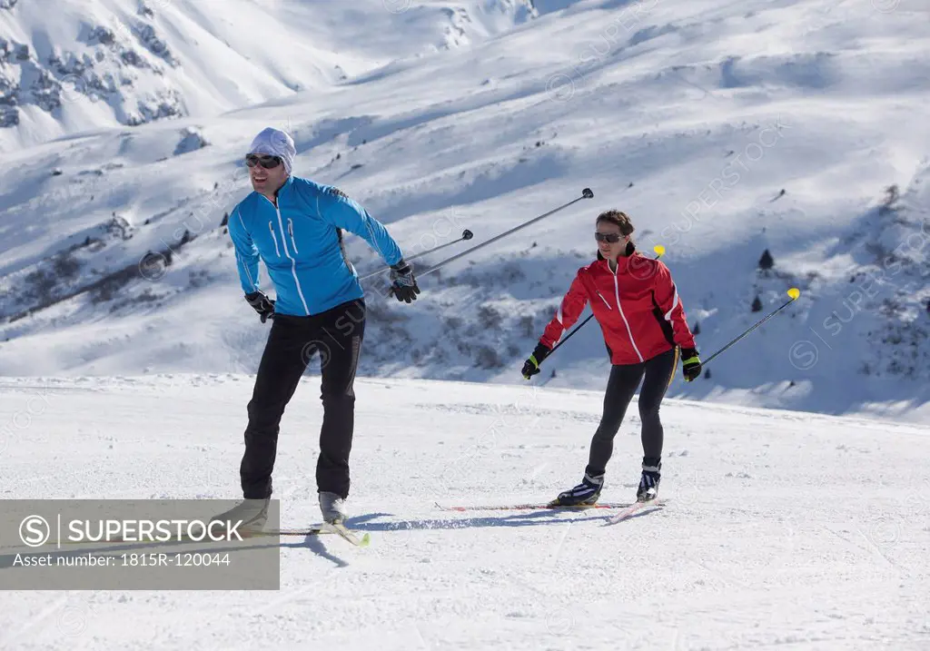 Germany, Man and woman skiing in snow