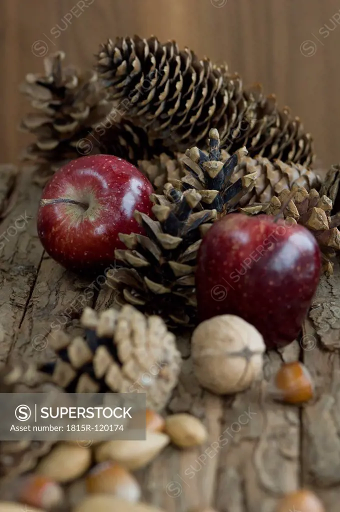 Apples, nuts and pine cones for christmas on table