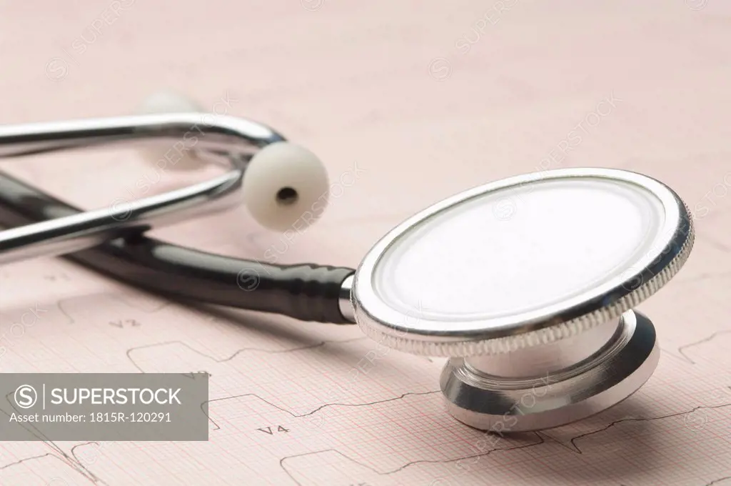 Stethoscope with ECG chart, close up