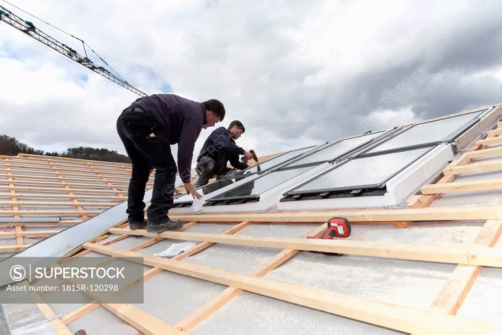 Europe, Germany, Rhineland Palatinate, Workers installing roof windows