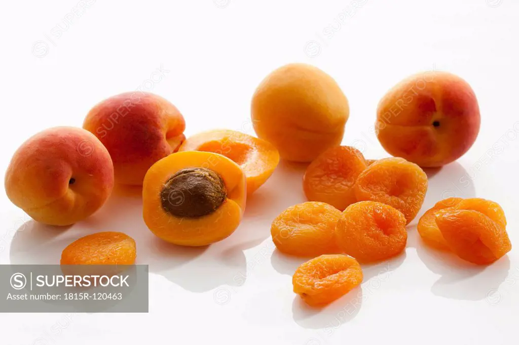 Fresh and dried apricots on white background, close up