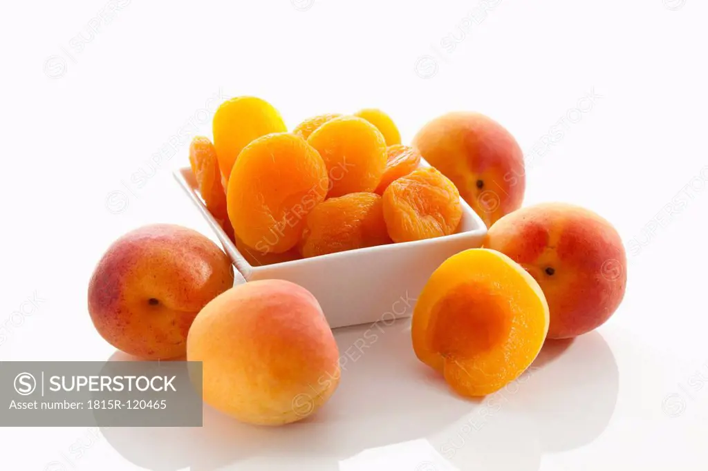 Fresh and dried apricots on white background, close up