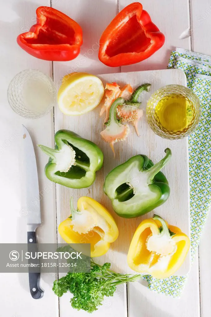 Various bell pepper with olive oil and parsley on table