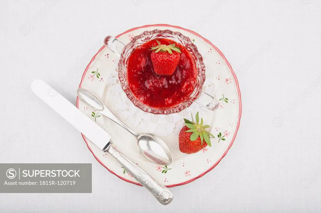 Bowl of fresh homemade strawberry jam on plate