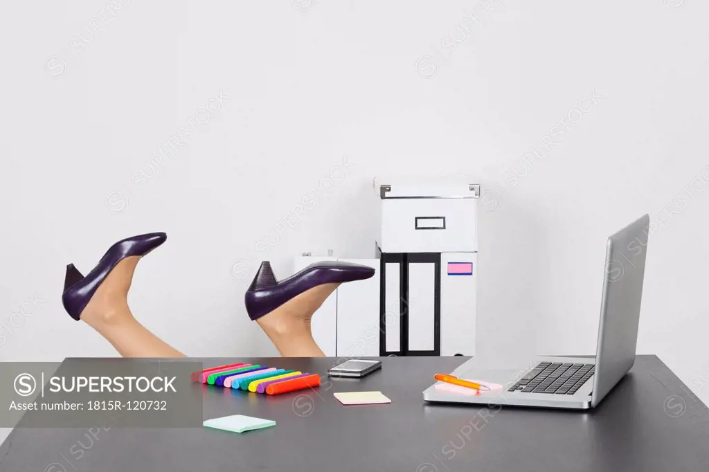 Business woman overturning behind office desk