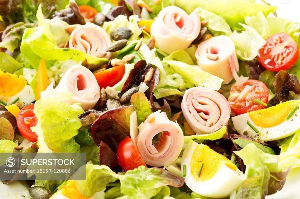 Salad with ham and cheese on white background, close up