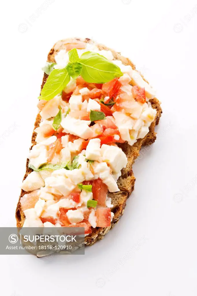 Mozzarella, tomatoes and basil on whole grain bread, close up