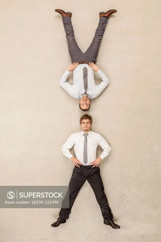 Businessmen with head to head position against beige background