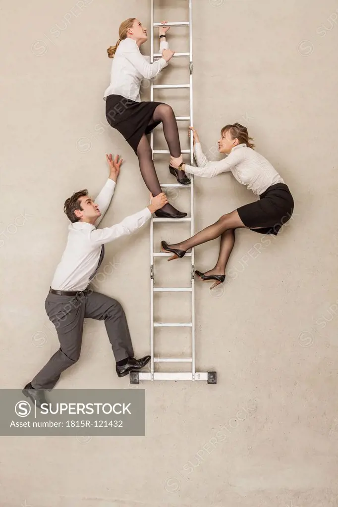 Business people climbing ladder in office