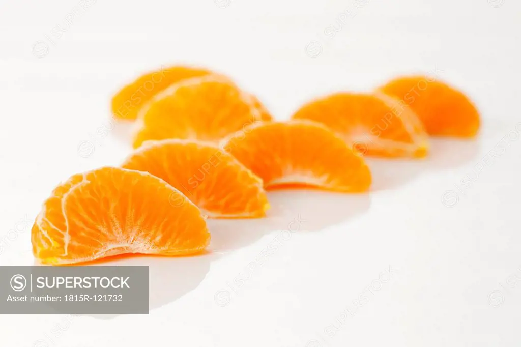 Peeled fresh clementines on white background, close up