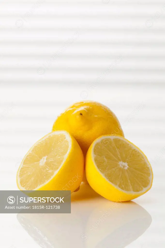 Whole and halved fresh lemons, close up