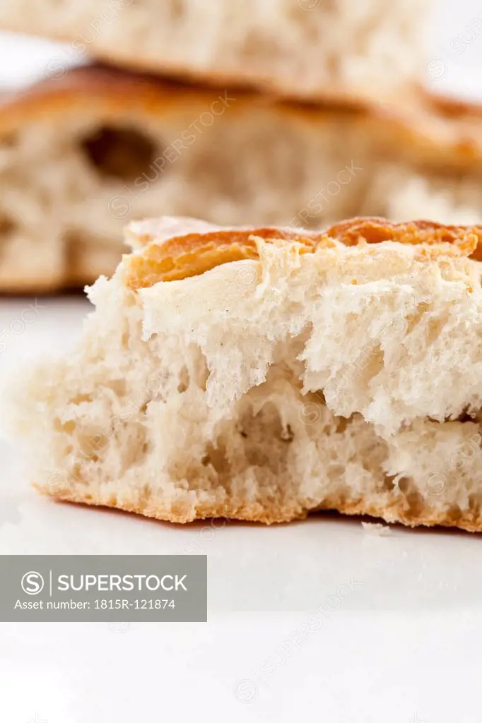 Slice of white bread on white background, close up