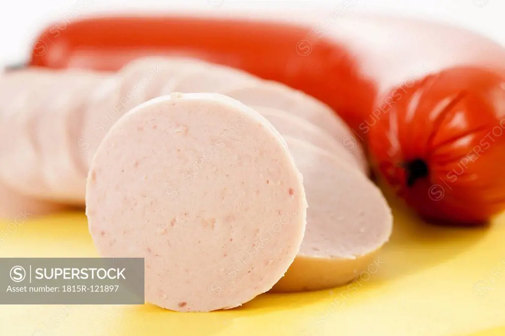 Fresh pork sausage on chopping board, close up