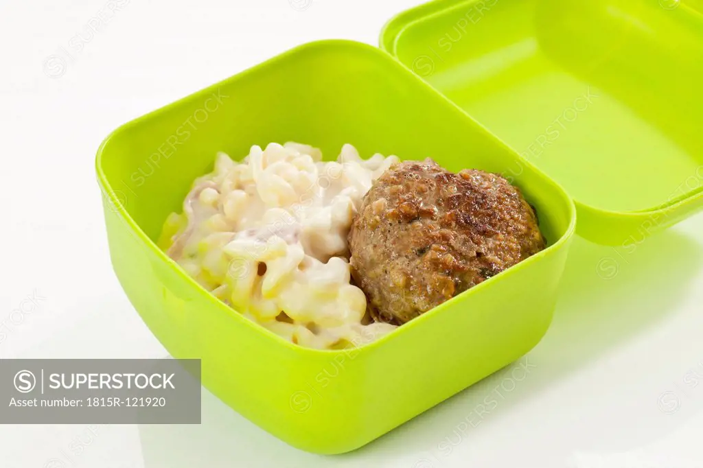 Pasta salad with meatball in lunch box, close up