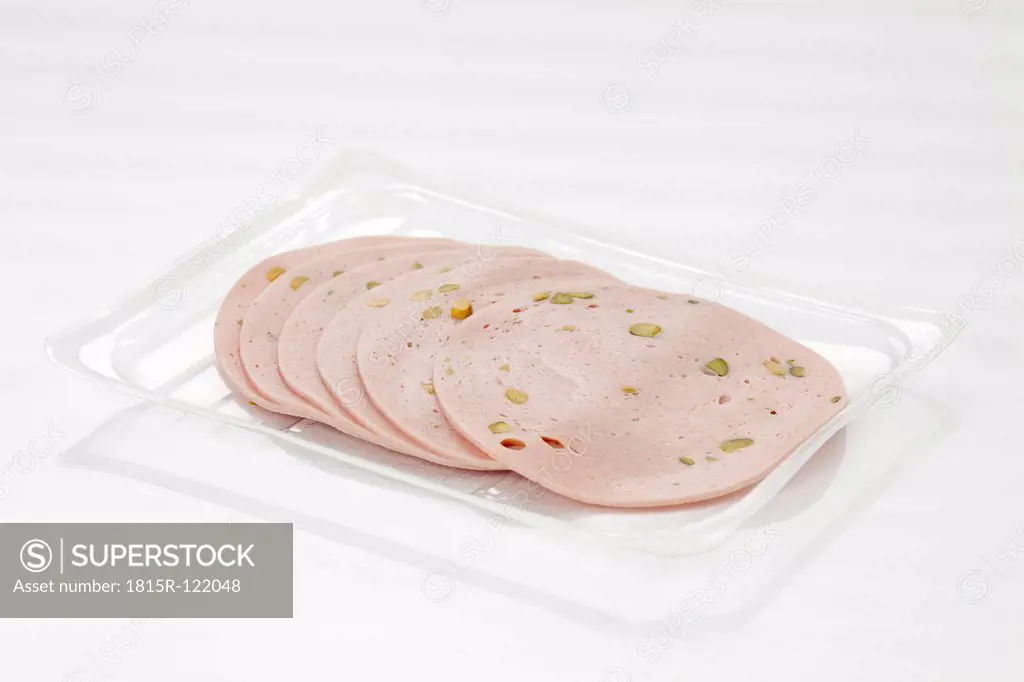 Mortadella sausage with pistachio in tray, close up
