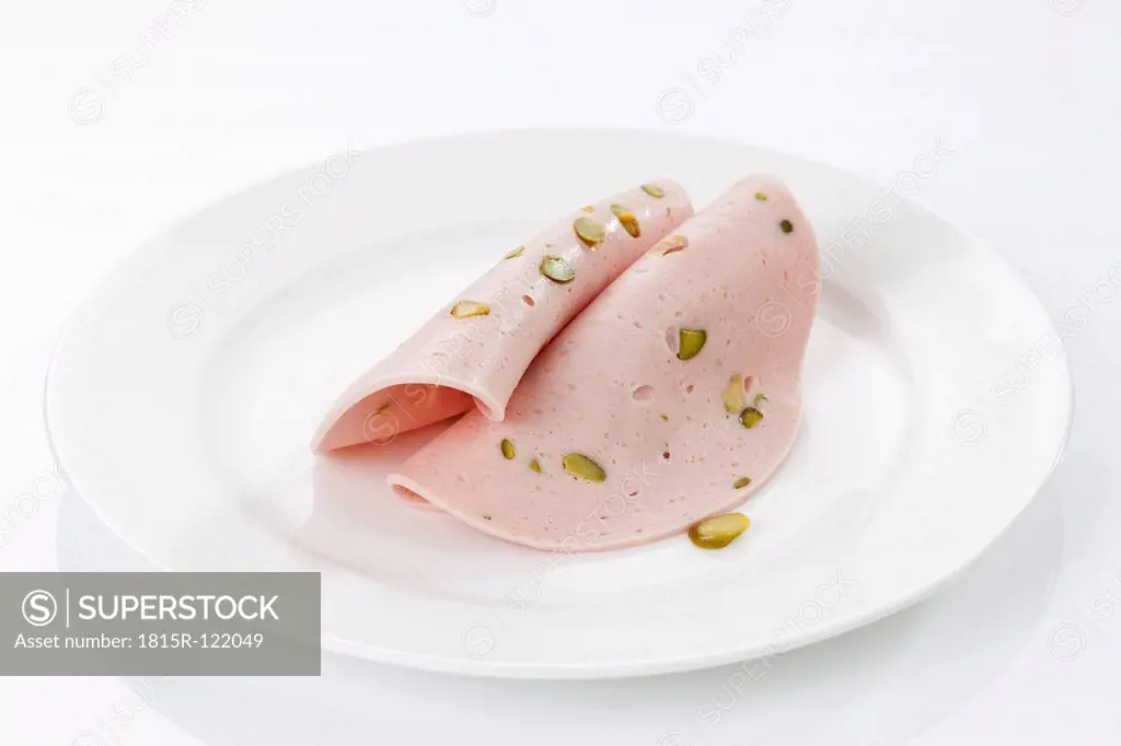 Plate of mortadella sausage with pistachio, close up