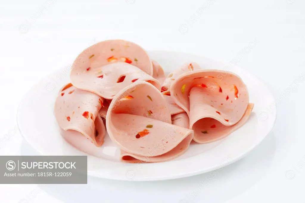 Plate of mortadella sausage with paprika, close up
