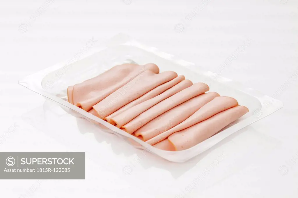 Mortadella sausage in plastic tray, close up