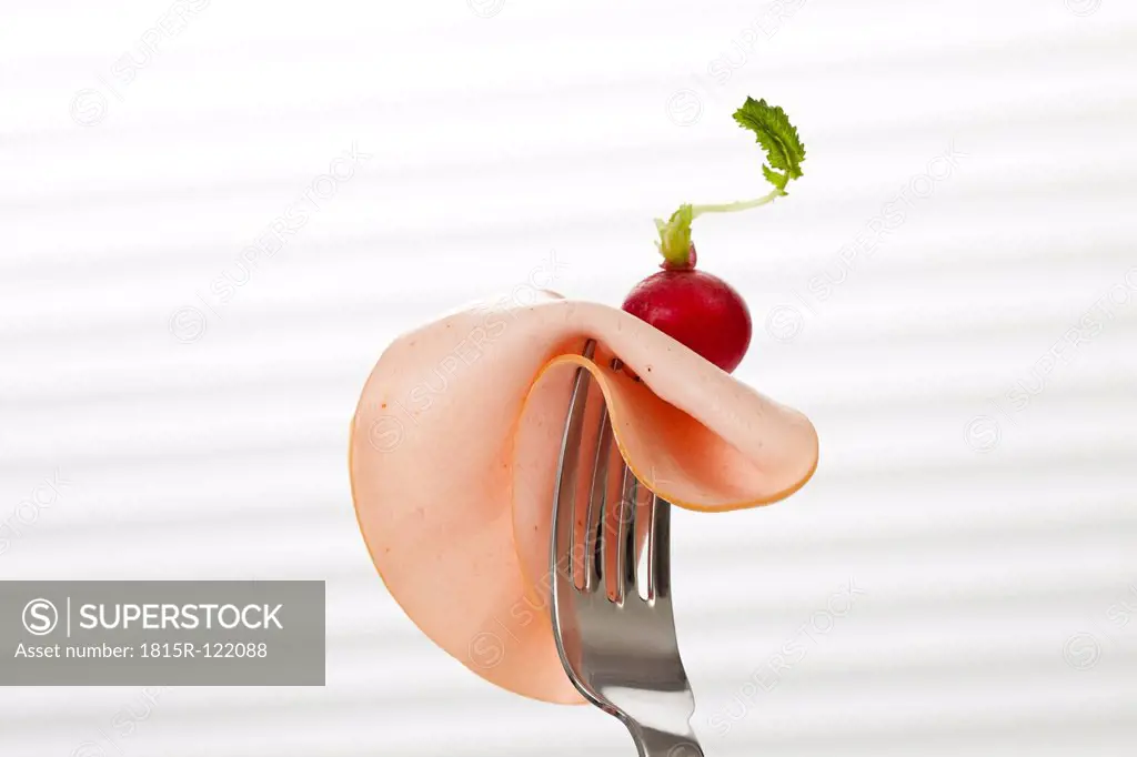 Mortadella sausage on fork, close up