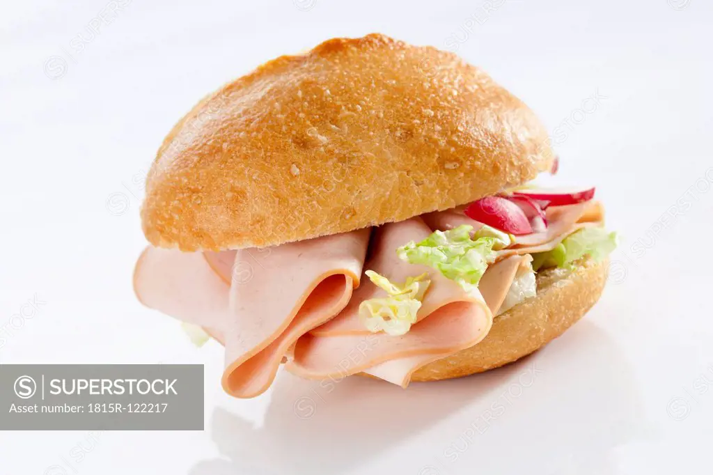 Sandwich of bread roll with mortadella and poultry on white background, close up