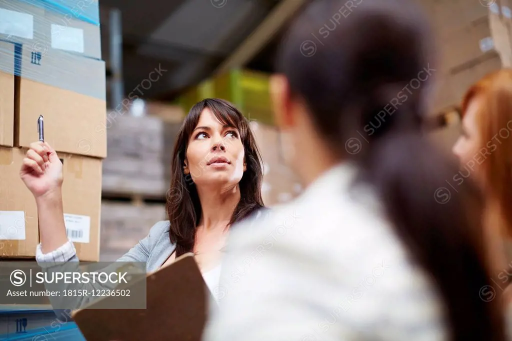 Woman with clipboard in warehouse