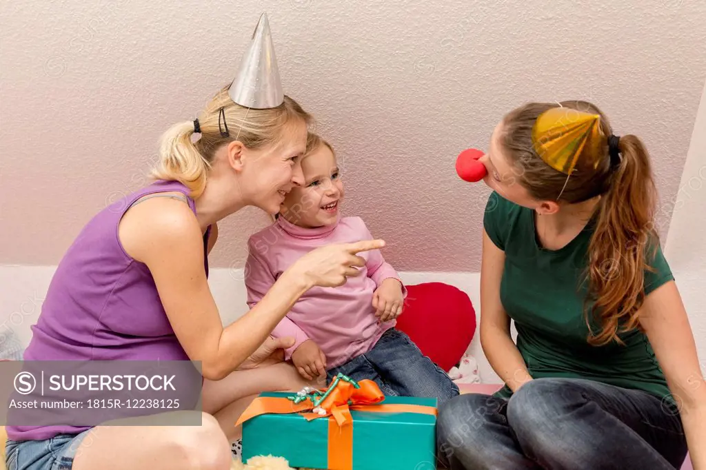 Two women and girl celebrating birthday