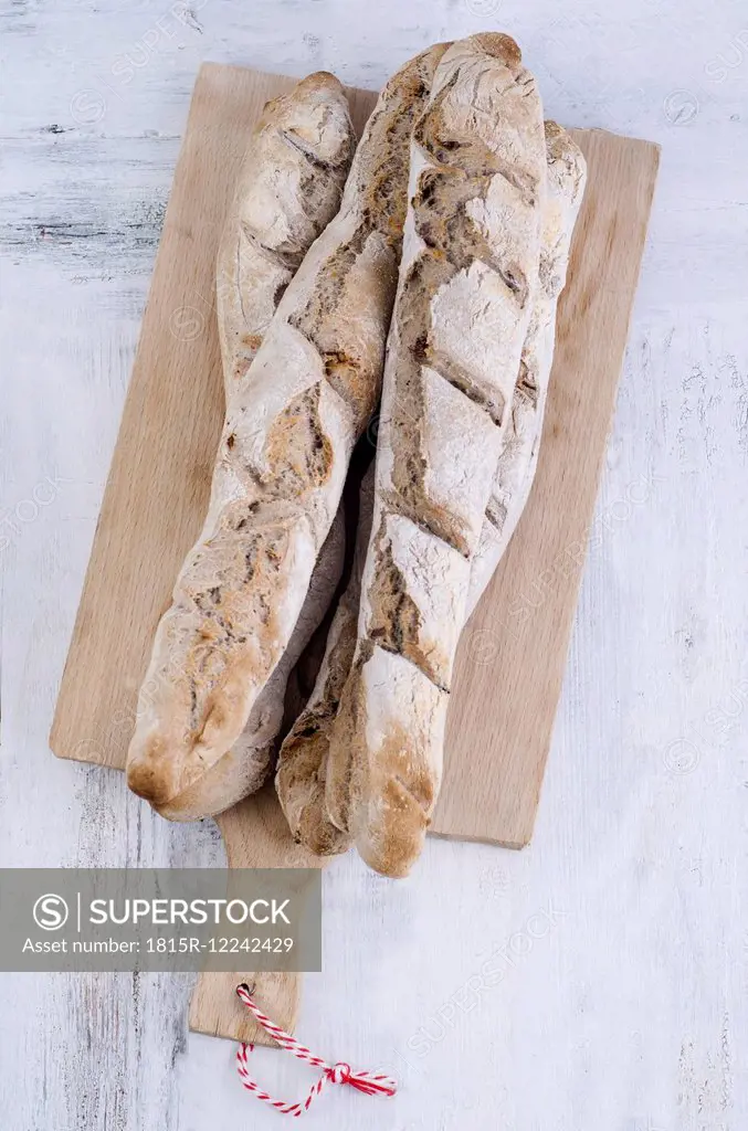 Home-baked baguettes on wooden board