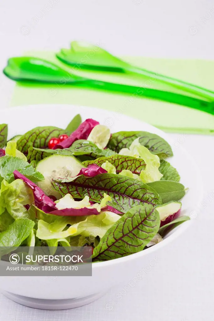 Bowl of fresh salad on white background, close up