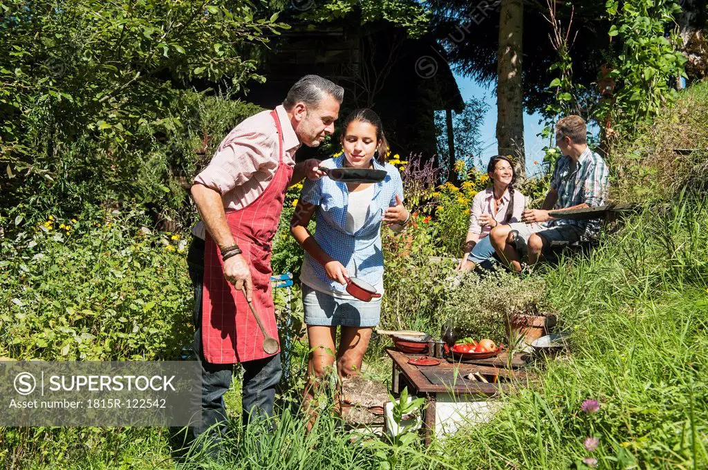 Austria, Salzburg Country, Man cooking for his family in garden