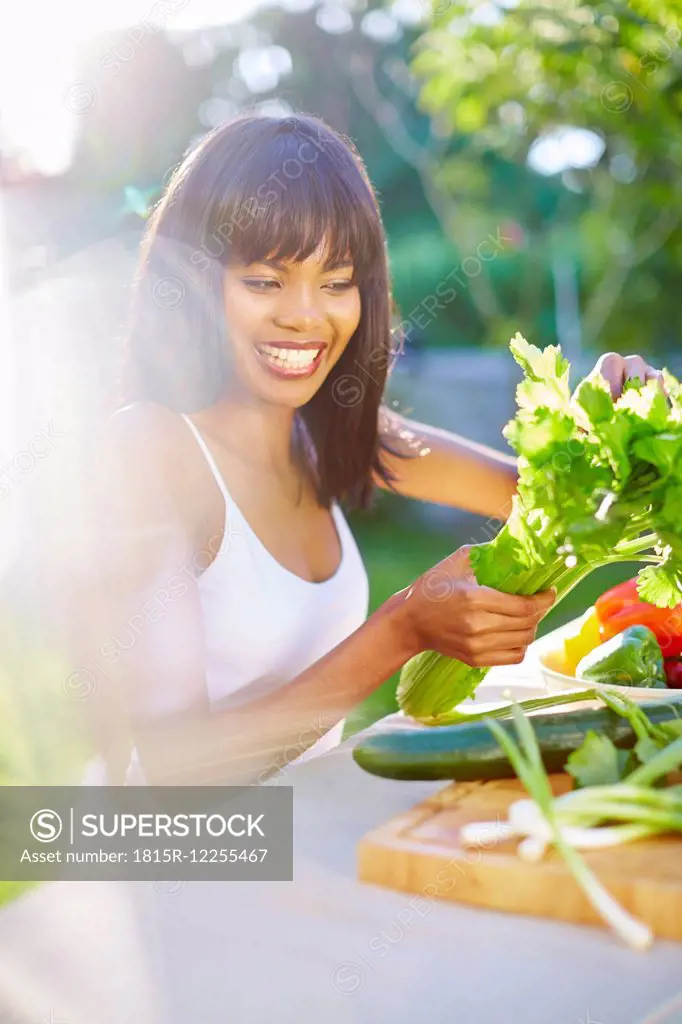 Young woman preparing healthy meal in garden