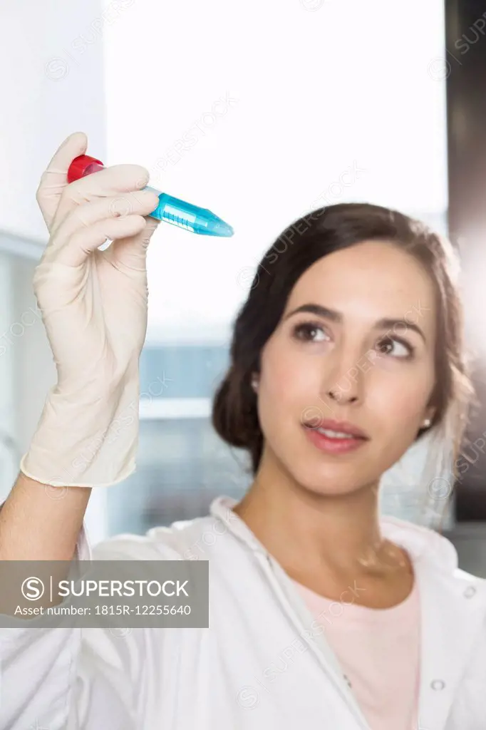 Female scientist checking test tube