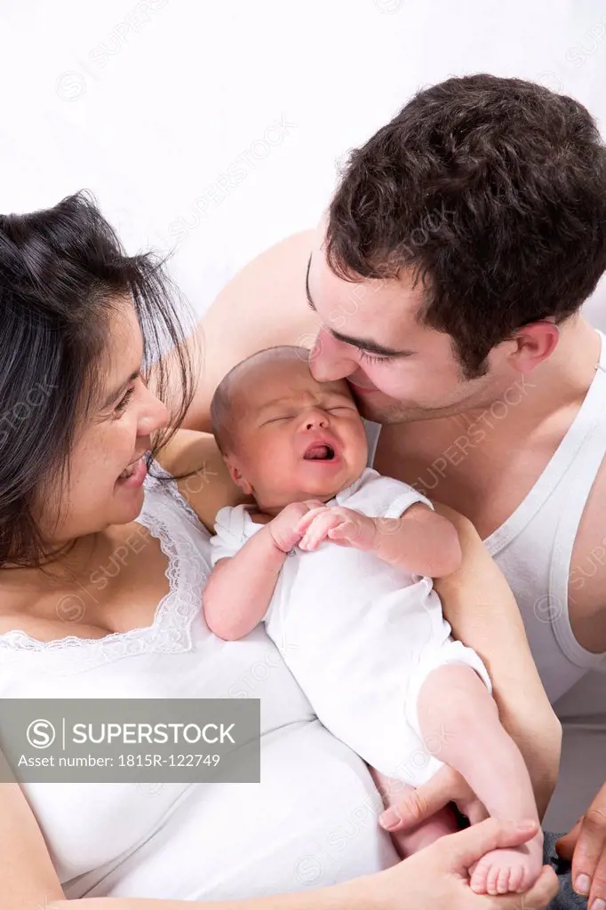 Parents with baby boy, smiling