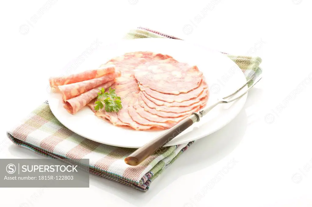 Plate of cheese sausage on white background, close up