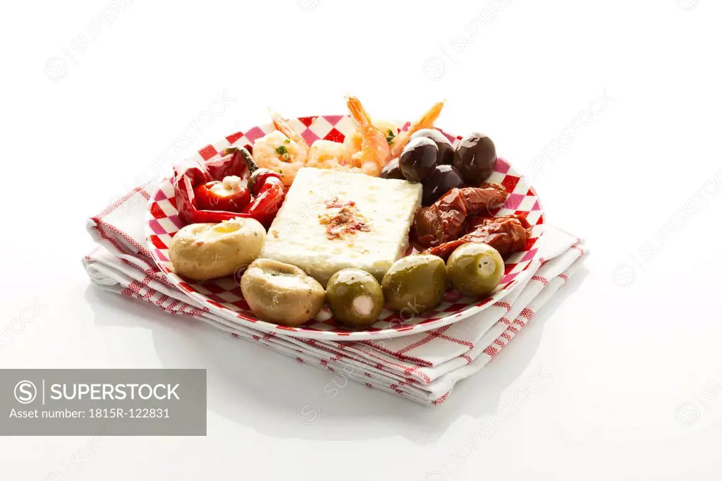 Various antipasti filled with soft cheese on plate, close up