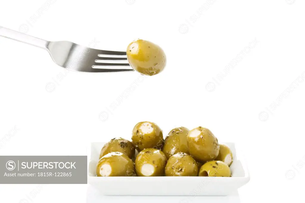 Olives filled with cheese on plate, close up