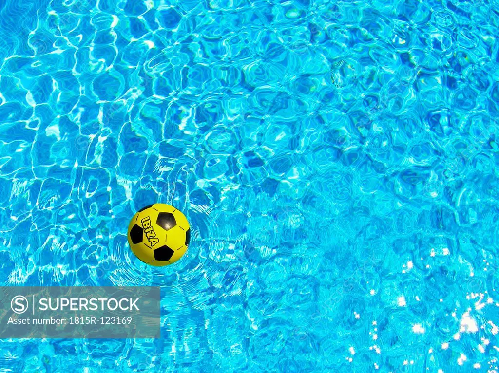 Spain, Football floating on water in pool