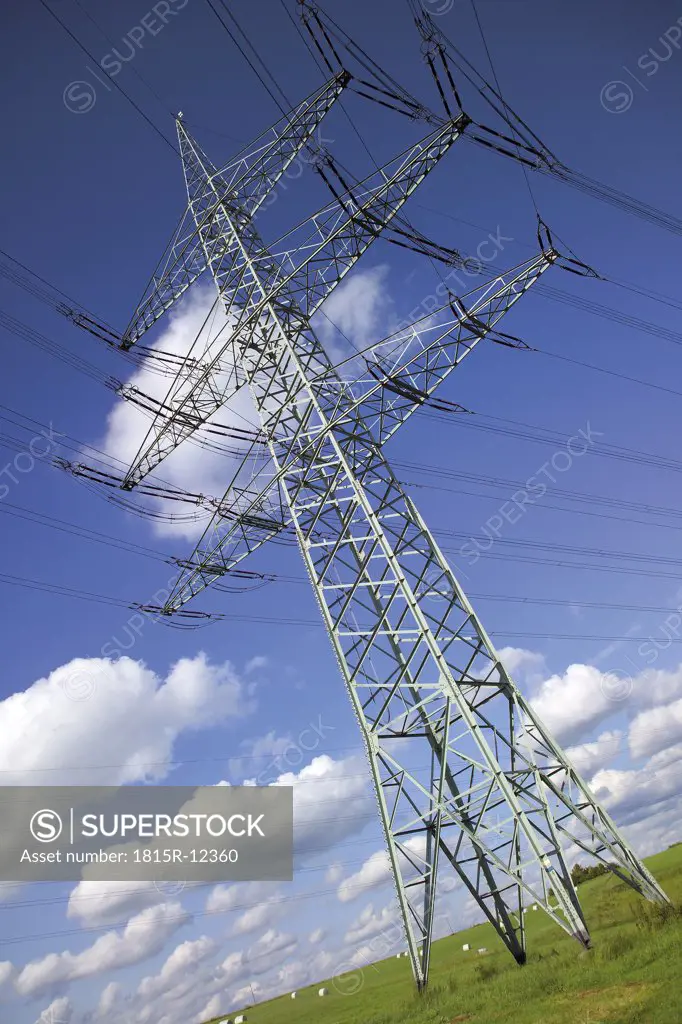 Electricity pylon in meadow, low angle view