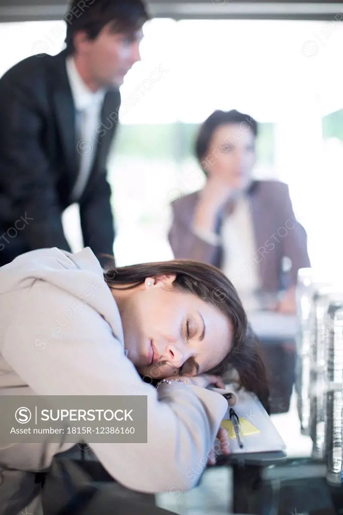 Woman sleeping during a business meeting