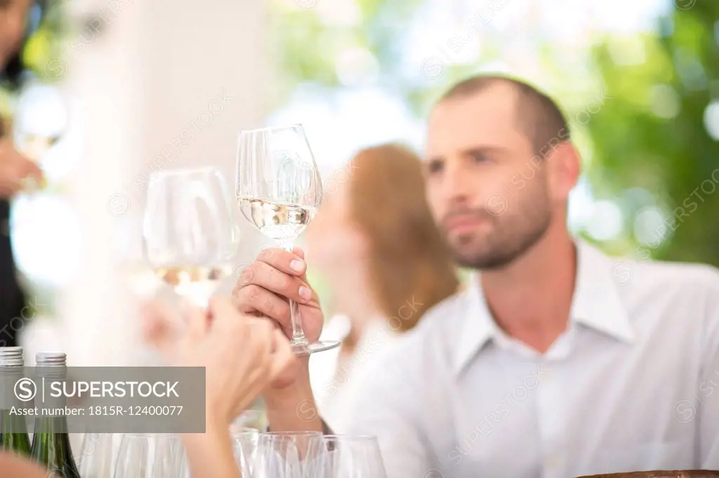 Man examining white wine on a wine tasting session