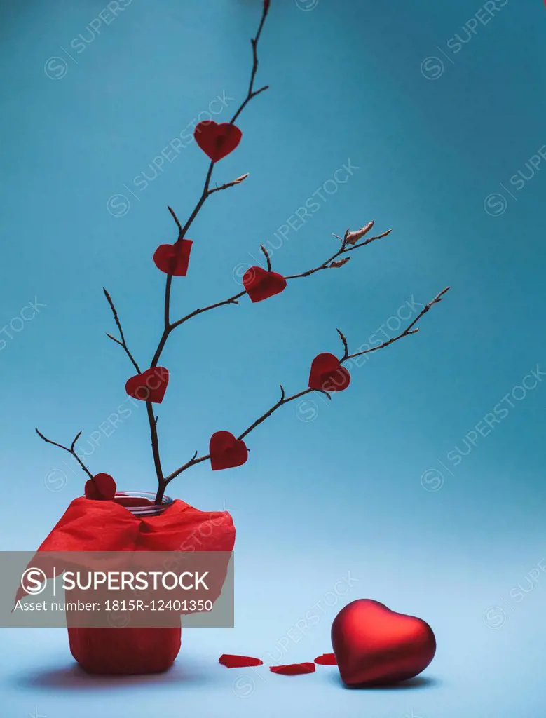 Fixed red paper hearts on a twig and red metallic heart