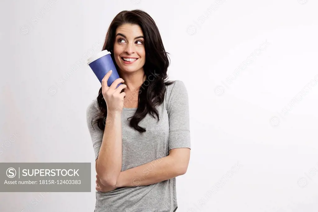 Portrait of smiling young woman with coffee to go